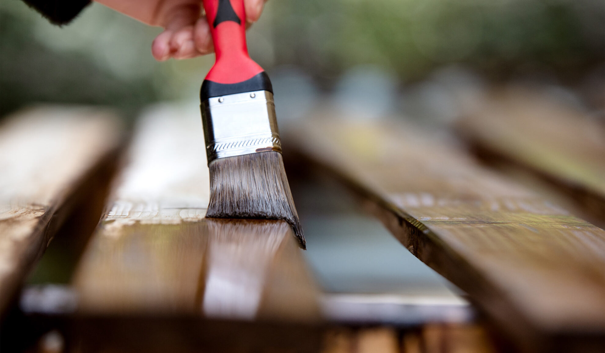 painting brush close up staining wooden deck bellbrook oh